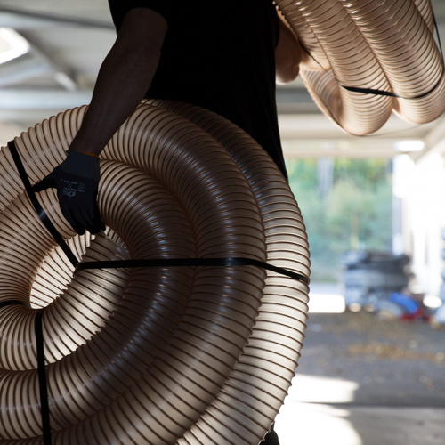 man carrying plastic hoses